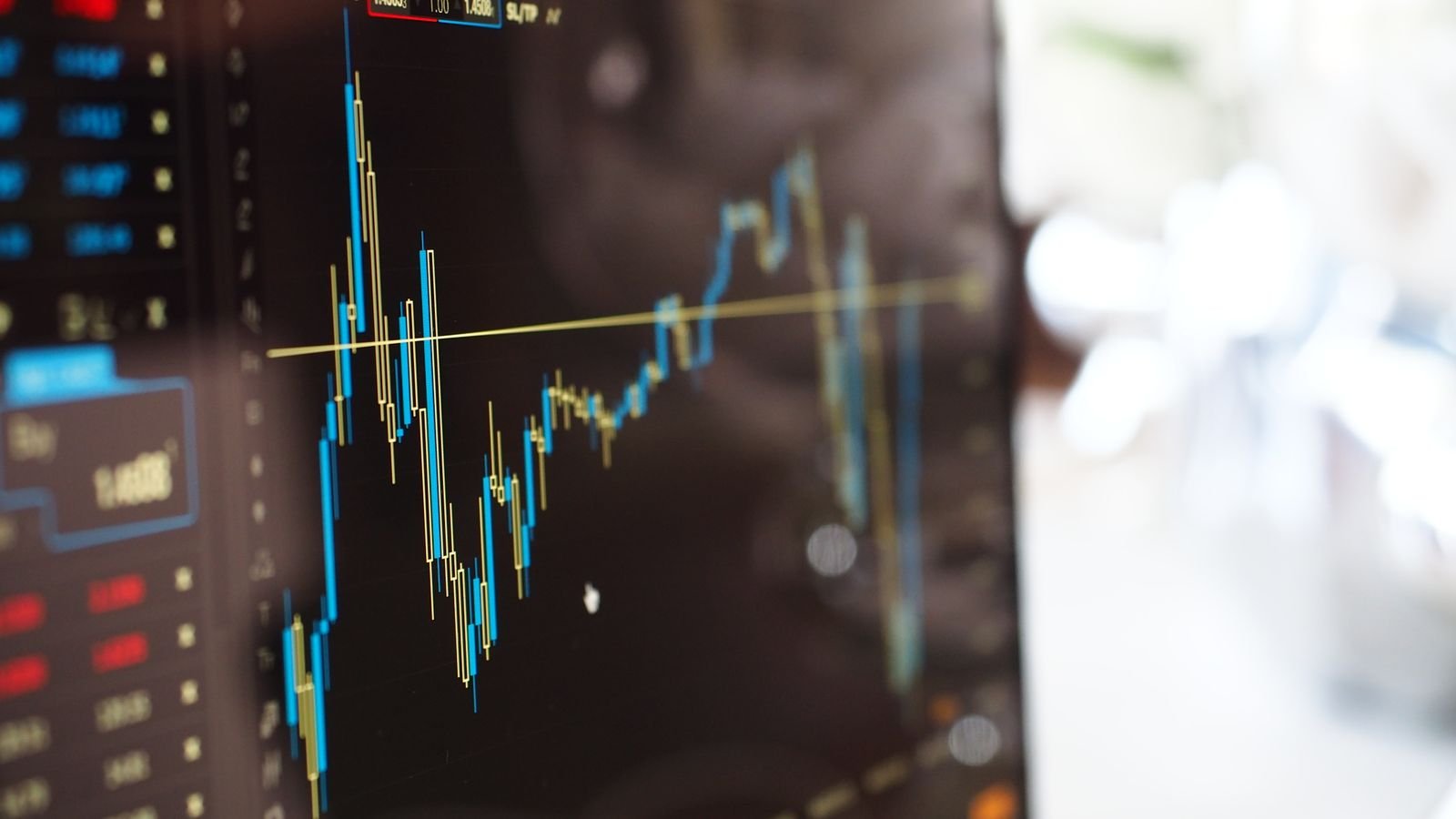 Close-up of a digital screen showing financial trading graphs, representing market pricing of Fed rate decision odds