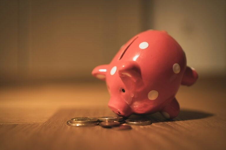 Pink piggy bank on a wooden table representing emergency savings