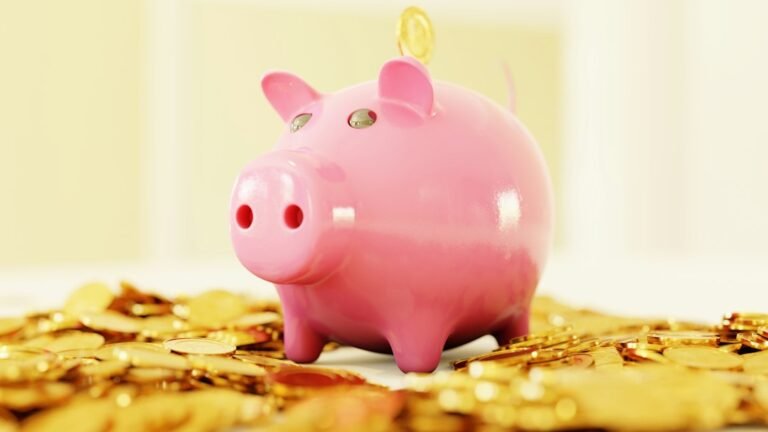 Pink piggy bank surrounded by gold coins representing retirement savings