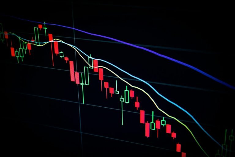 Stock market candlestick chart on a dark screen, representing placing a stock order